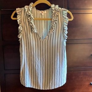 Women’s ruffled neck sleeveless top with metallic stripes.